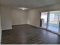 Bright living room featuring dark gray vinyl flooring and sliding glass doors at 525 E Roberts St, Orange City, FL 32763