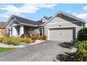 This lovely home features a paver driveway and nicely landscaped front yard at 628 Mosaic Blvd, Daytona Beach, FL 32124