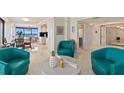 Open concept living space with teal armchairs and ocean views at 2200 N Atlantic Ave # 2101, Daytona Beach, FL 32118