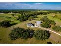 Aerial view showcasing house, barn, and surrounding land at 575 Alderman Rd, Lakeland, FL 33810