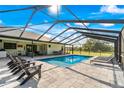 Relaxing pool area with covered patio and lounge chairs at 575 Alderman Rd, Lakeland, FL 33810