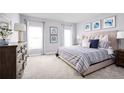Main bedroom featuring a king-size bed, dresser, and plenty of natural light at 1235 Tank Trl, Haines City, FL 33844