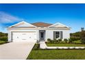 One-story house with light blue exterior, gray shutters, and a two-car garage at 1235 Tank Trl, Haines City, FL 33844