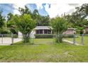 Brick ranch house with a fenced yard and landscaping at 614 Powell St, Wildwood, FL 34785