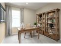 Home office with built-in shelving and a writing desk at 3022 Ruby Falls Dr, Deland, FL 32724