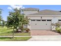 Attached garage with brick driveway, offering convenient parking at 2541 Yellow Brick Rd, Saint Cloud, FL 34772