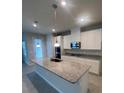 Modern kitchen with large island and granite countertops at 3868 Denali Dr, Apopka, FL 32712