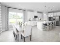 Modern kitchen with white cabinets, stainless steel appliances, and a large island at 360 Crossings Ave, St Cloud, FL 34771