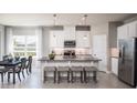Modern kitchen featuring granite countertops, white cabinets, and a large island at 814 Canyon Creek Dr, New Smyrna Beach, FL 32168