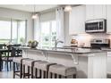 Spacious kitchen with granite countertops, white cabinets, and stainless steel appliances at 814 Canyon Creek Dr, New Smyrna Beach, FL 32168