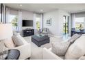 Bright living room with comfy sofas and a large TV at 1897 Basenji Dr, Lake Alfred, FL 33850