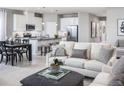 Open concept living and kitchen area with white sofas at 1897 Basenji Dr, Lake Alfred, FL 33850