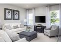 Bright living room featuring comfy seating and large windows at 1897 Basenji Dr, Lake Alfred, FL 33850