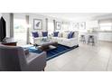 Open concept living and kitchen area with tile floors and modern appliances at 1641 Laia Rd, Haines City, FL 33844