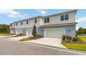 Three-unit townhome building with attached garages and landscaping at 6923 Five Oaks Dr, St Cloud, FL 34773