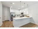 Modern white kitchen with stainless steel appliances and an island at 6923 Five Oaks Dr, St Cloud, FL 34773