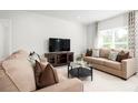 Open-concept living space with neutral decor and cozy seating at 1602 Minnesota Rd, Sumterville, FL 33585