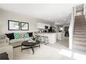 Open concept living room with kitchen and staircase views at 2310 Incandescent Way, South Daytona, FL 32119
