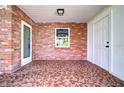 Brick front porch with terracotta tile flooring at 616 Powell St, Wildwood, FL 34785