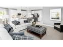 Open living room and kitchen with white cabinets and gray walls at 5724 Freshwater Canyon Dr, St Cloud, FL 34771