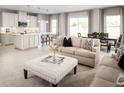 Open-concept kitchen with an island, white cabinets, and stainless steel appliances at 5745 Anders Way, St Cloud, FL 34771