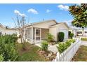 Home exterior showcasing a screened porch and well-manicured landscaping at 1052 Ridgeville Rd, The Villages, FL 32162