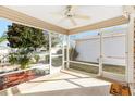 Spacious screened porch with ceiling fan, providing an outdoor living space at 1052 Ridgeville Rd, The Villages, FL 32162