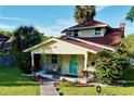 Nice yellow house with red roof, porch, and lush landscaping at 104 Sunset Way, Fruitland Park, FL 34731