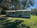 Another side view of a light green single-wide mobile home at 3882 Se 108Th Ln, Webster, FL 33597