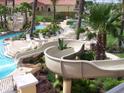 Community pool area with water slide and lounge chairs at 216 Calabria Ave, Davenport, FL 33897
