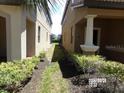 Narrow side yard between two homes with some landscaping at 5537 Misty Oak Cir, Davenport, FL 33837