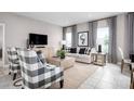 Spacious living room with comfortable seating and a neutral color scheme at 10918 Sw 73Rd Ct, Ocala, FL 34476