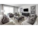 Living room with modern decor, cozy seating, and large TV at 7416 Sw 107Th Ln, Ocala, FL 34476