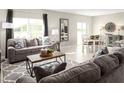 Open living and dining area with gray sofas and tile floors at 1657 Laia Rd, Haines City, FL 33844