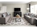 Spacious living room with gray sofas and patterned rug at 1657 Laia Rd, Haines City, FL 33844