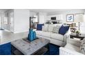 Open living space with light-colored sofa, blue accents, and kitchen views at 1661 Laia Rd, Haines City, FL 33844