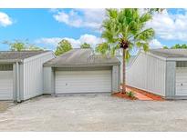 Attached garage with a pathway to the unit entrance at 1502 Ne Buckeye Ne Rd # 2, Winter Haven, FL 33881