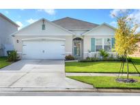 One-story home with a two-car garage, landscaping, and neutral exterior at 2638 Galway Grove Way, Lakeland, FL 33811