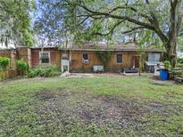 Large backyard with mature trees and a home needing some TLC at 1025 Browning Rd, Lakeland, FL 33811