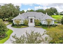 Luxury home exterior with circular driveway and landscaped yard at 4015 Nw 85Th Ter, Ocala, FL 34482
