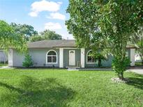 Gray house with a green lawn and palm trees at 5337 Jacob Ave, Polk City, FL 33868