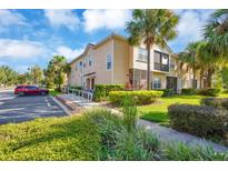 Condo building exterior with landscaping and parking at 2711 Oakwater Dr # 116, Kissimmee, FL 34747