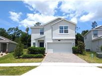 Two-story house with gray exterior, two-car garage, and landscaped front yard at 2905 Black Birch Dr, Ocoee, FL 34761