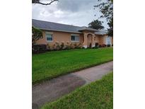 Single-story home with a well-maintained lawn and inviting entryway at 3110 Port Royal Dr, Orlando, FL 32827