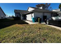 Front yard of a two-story home with a two-car garage and green lawn at 4520 Summergrove Ave, Orlando, FL 32812