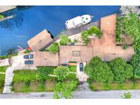 Aerial view of waterfront home with boat dock and lush landscaping at 24120 Mink Rd, Astor, FL 32102