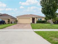 Single-story house with brick paver driveway and 2-car garage at 4814 Rockvale Dr, Kissimmee, FL 34758