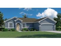 One-story home with gray exterior, two-car garage, and landscaping at 10891 Sw 41St Ave, Ocala, FL 34476