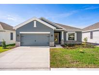 Two-car garage, gray exterior home with stone accents at 2350 Selenia St, Lake Alfred, FL 33850