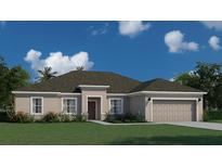 One-story home with a two-car garage, dark roof, and landscaping at 6107 Sw 115Th Street Rd, Ocala, FL 34476
